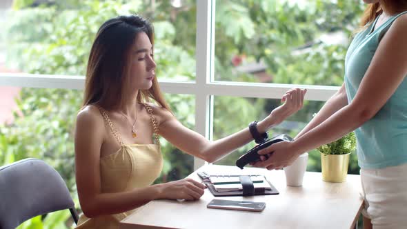 Young pretty woman use smart watch contactless payment 