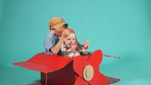 Cute Dreamer Boys Flying in Cardboard Airplane