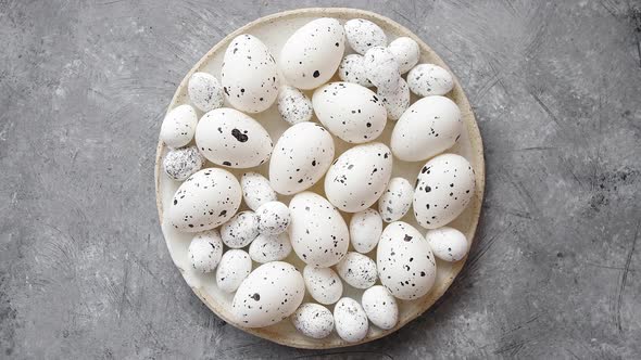 Composition of White Traditional Dotted Easter Eggs in White Ceramic Plate