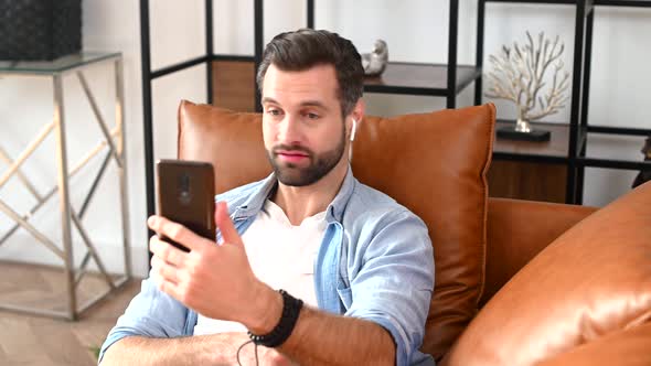 A Young Handsome Guy Using a Mobile Phone for Video Call