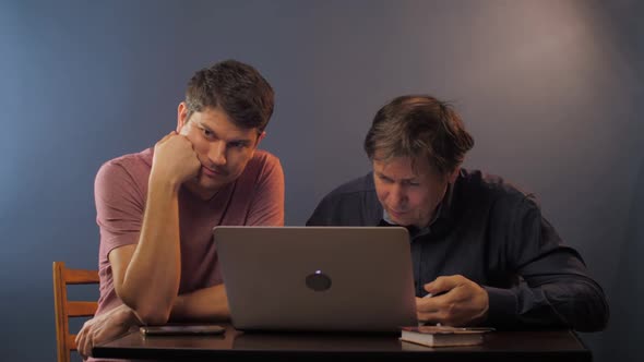 Man Tied Explain How To Work with Laptop Senior Colleague