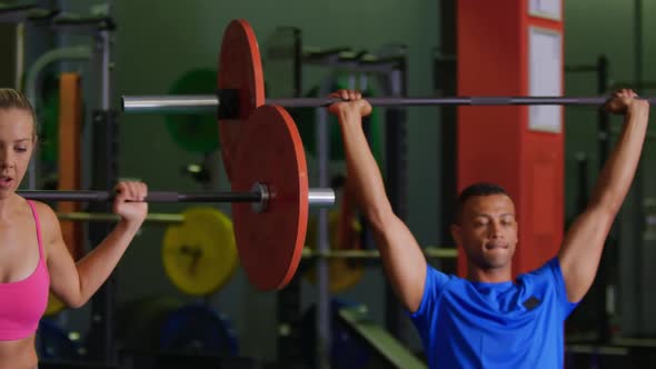 Man and woman exercising in a gym