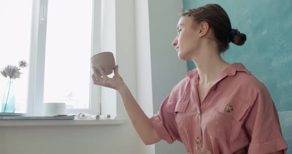 Female Potter Sitting and Makes a Cup. Woman Making Ceramic Item. Pottery Working, Handmade and