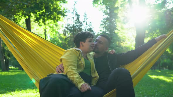 Couple relaxing in a hammock on a sunny day