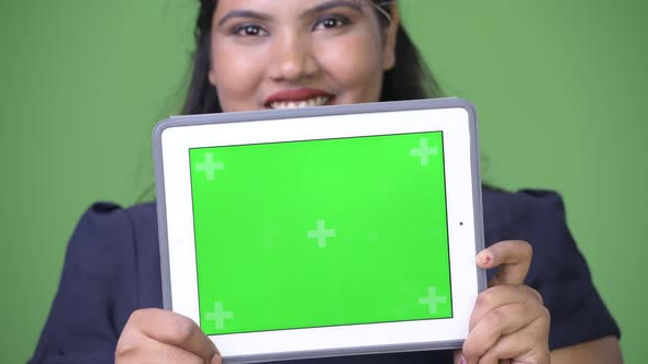 Young Overweight Beautiful Indian Businesswoman Against Green Background