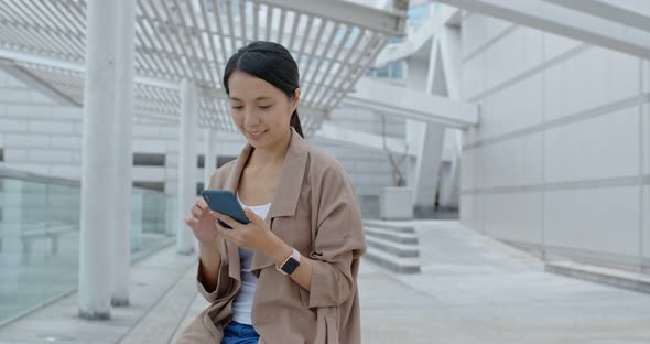 Young woman use of mobile phone in city