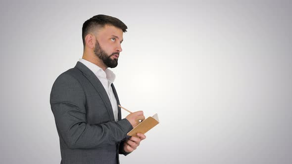 Business Man Writing Down Ideas on Gradient Background