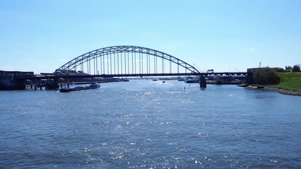 Arch Bridge Over Noord River With Sailing Barge At Daytime In Hendrik-Ido-Ambacht, Netherlands. - ae