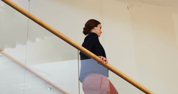 Businesswoman walking down stairs 4k