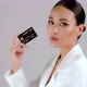 Beautiful Asian businesswoman showing credit card and looking at camera - VideoHive Item for Sale