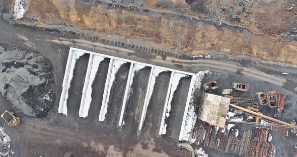 Aerial View of the Open Pit Loader Loading Gravel Into Stone Jaw Crusher in Openpit Quarry