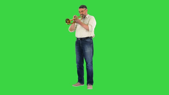 Senior Musician Playing a Trumpet on a Green Screen Chroma Key