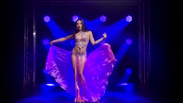 Oriental Belly Dancer Is Dancing and Demonstrating the Flexibility and Attractiveness of Her Body