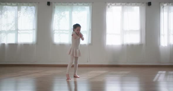 Little girl dancing alone in a studio