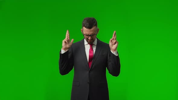 Helpless Handsome Brunette Man with Beard in Suit Holding Crossed Fingers for Good Luck and Saying