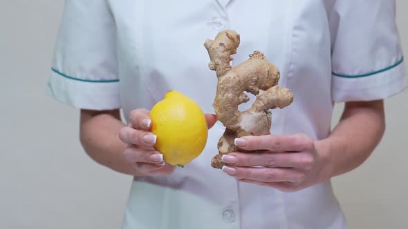 Nutritionist Doctor Healthy Lifestyle Concept - Holding Ginger Root and Lemon Fruit