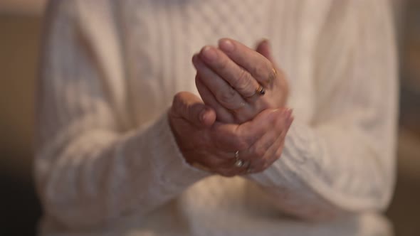 Closeup Senior Wrinkled Female Hands Rubbing Moisturizer Indoors