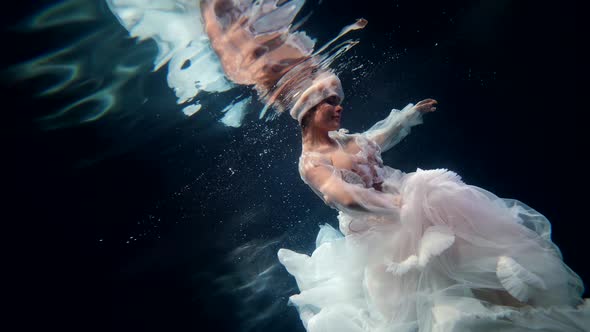 Enigmatic Underwater Shot with Fabulous Undersea Fairy in White Gown Graceful Lady