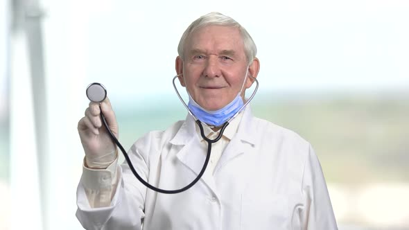 Old Senior Cheerful Doctor with Stethoscope