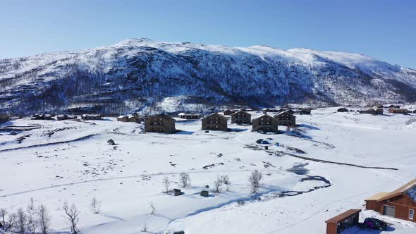 Sideways moving aerial overview of lodging apartments with ski-in at Hardangervidda mountain - Maurs