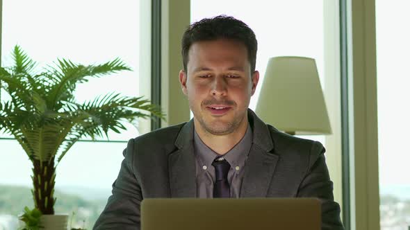 Young Handsome Businessman Working in Modern Office