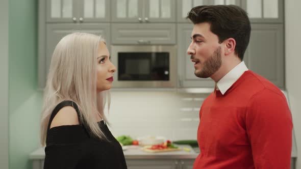 Couple talking in the kitchen