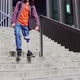 Young man with prosthetic leg walking down stairs in the city - VideoHive Item for Sale