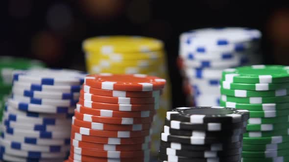 Colorful Casino Chips Turning Around, Female Hand Taking Some Tokens to Make Bet