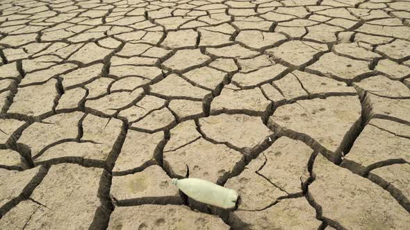 Bottom of the Empty Studena Dam with Empty Plastic Bottle on the Cracked Earth, Bulgaria