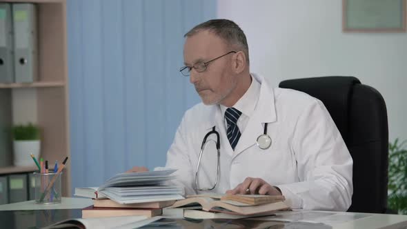 Doctor Examining Medical Science Literature to Diagnose Seriously Ill Patient