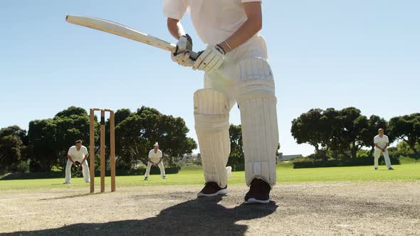 Batsman playing straight drive during cricket match