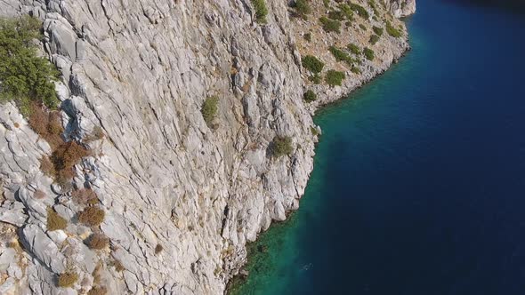 Rocky Steep Wall Cliff by the Seashore in Untouched Sea