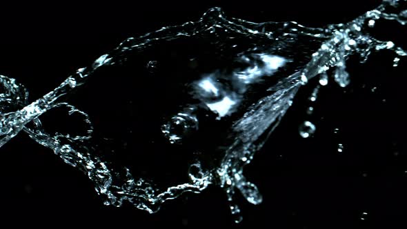 Super Slow Motion Shot of Swirling and Splashing Water Isolated on Black Background at 1000Fps.