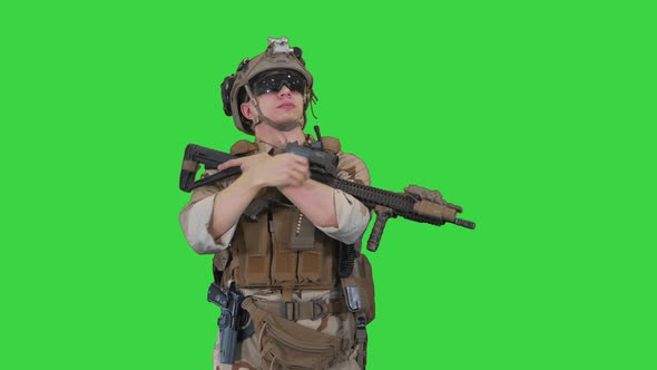 Tired US Marine with a Assault Rifle Standing on a Green Screen, Chroma Key.