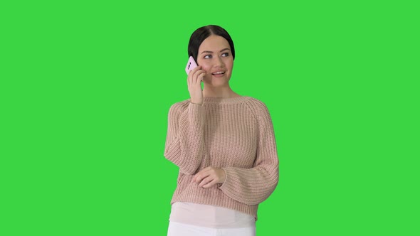 Emotional Smiling Young Woman Talking on the Phone and Gesturing on a Green Screen Chroma Key