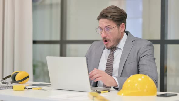 Middle Aged Engineer Reacting to Loss While using Laptop