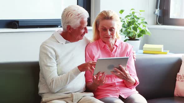 A senior couple using tablet computer