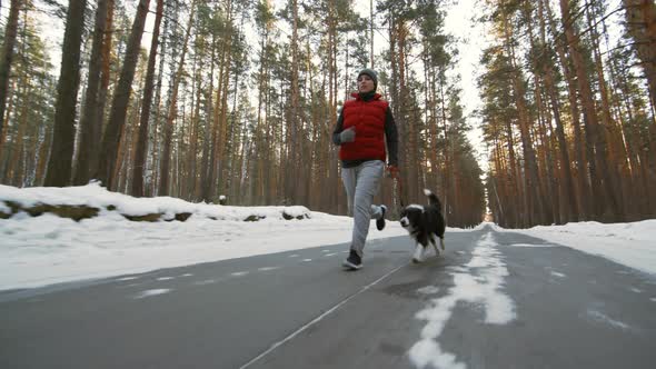 Woman and Dog Jogging on Winter Day