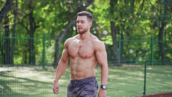 Muscular runner on the outdoor stadium. 