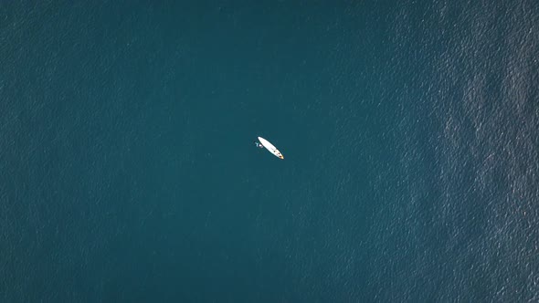 A Man Drifts Surfing the Sea Aerial View 4 K