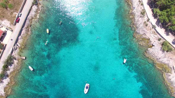 Aerial view of people swimming in turquoise bay