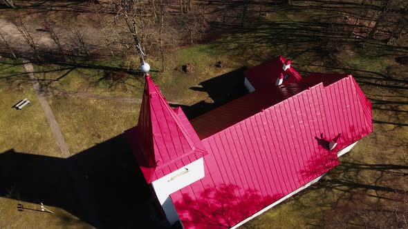 Aerial view of Lielvarde (Latvia) Lutheran church at the bank of Daugava river, white church with re