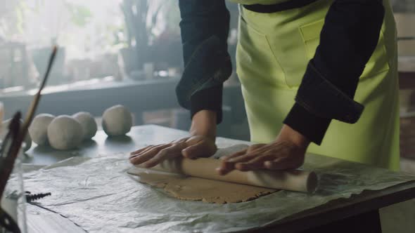 Rolling Out Piece of Raw Clay