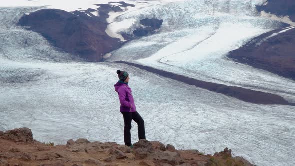 Women Rises on a Mountain Ridge