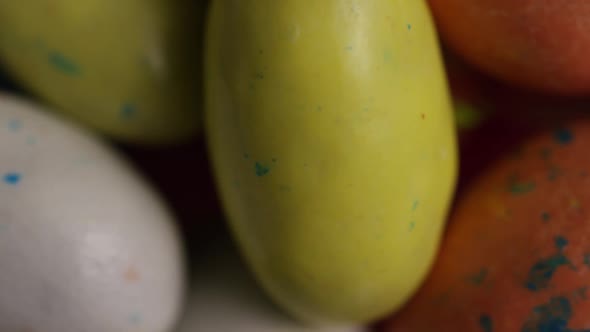 Rotating shot of colorful Easter candies on a bed of easter grass