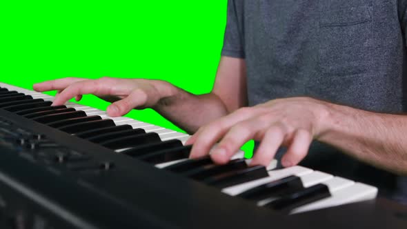 Mid section of musician playing electronic piano