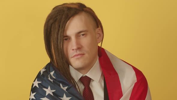 Young Man with American Flag on Yellow Background