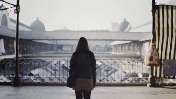 Portuguese Woman Walks Towards The Railings In Porto, Portugal. Domes Of Porto Cathedral In The Fogg