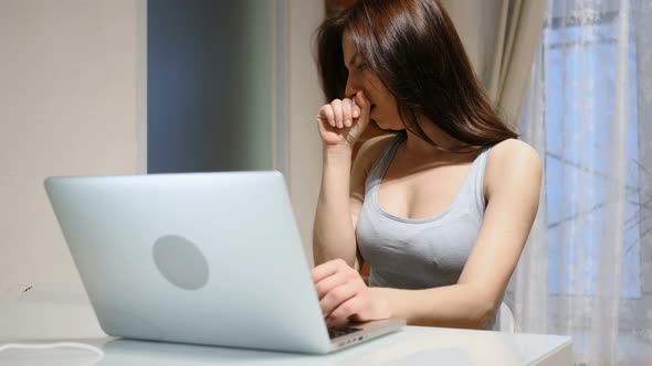 Portrait of Sick Woman Coughing while Working on Laptop, Infection