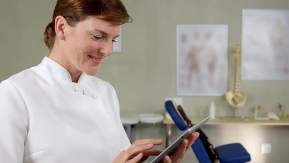 Female physiotherapist using digital tablet